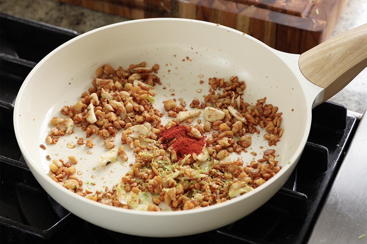 adding spices to the crispy lime tempeh