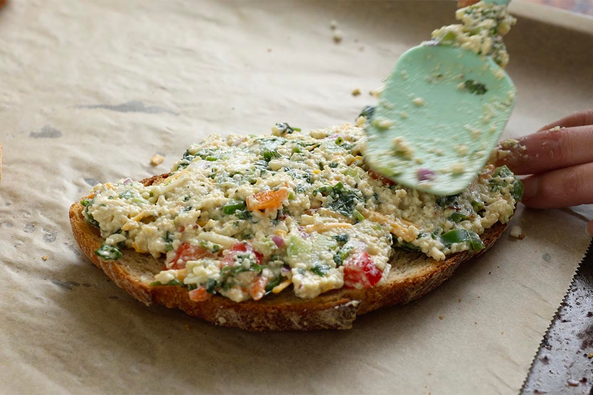 spreading the tofu mixture onto the bread