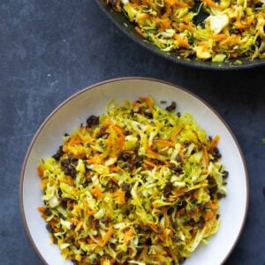 bowl of sambharo-inspired cabbage salad next to the pan