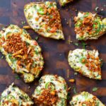 Indian chilli cheese toasts on a cutting board with some sliced in half