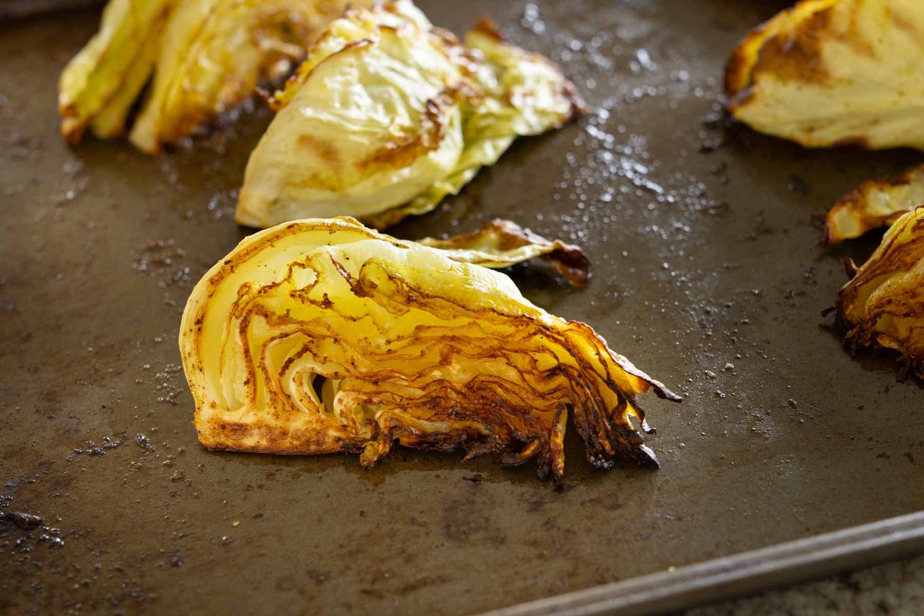 close-up of roasted cabbage on the baking sheet after baking