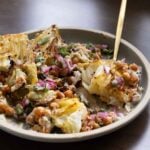 fork taking a bite of the roasted cabbage wedge