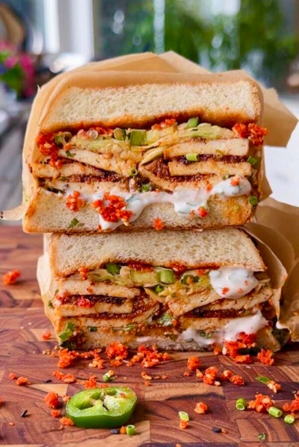 stack of coconut tofu sandwiches on a cutting board