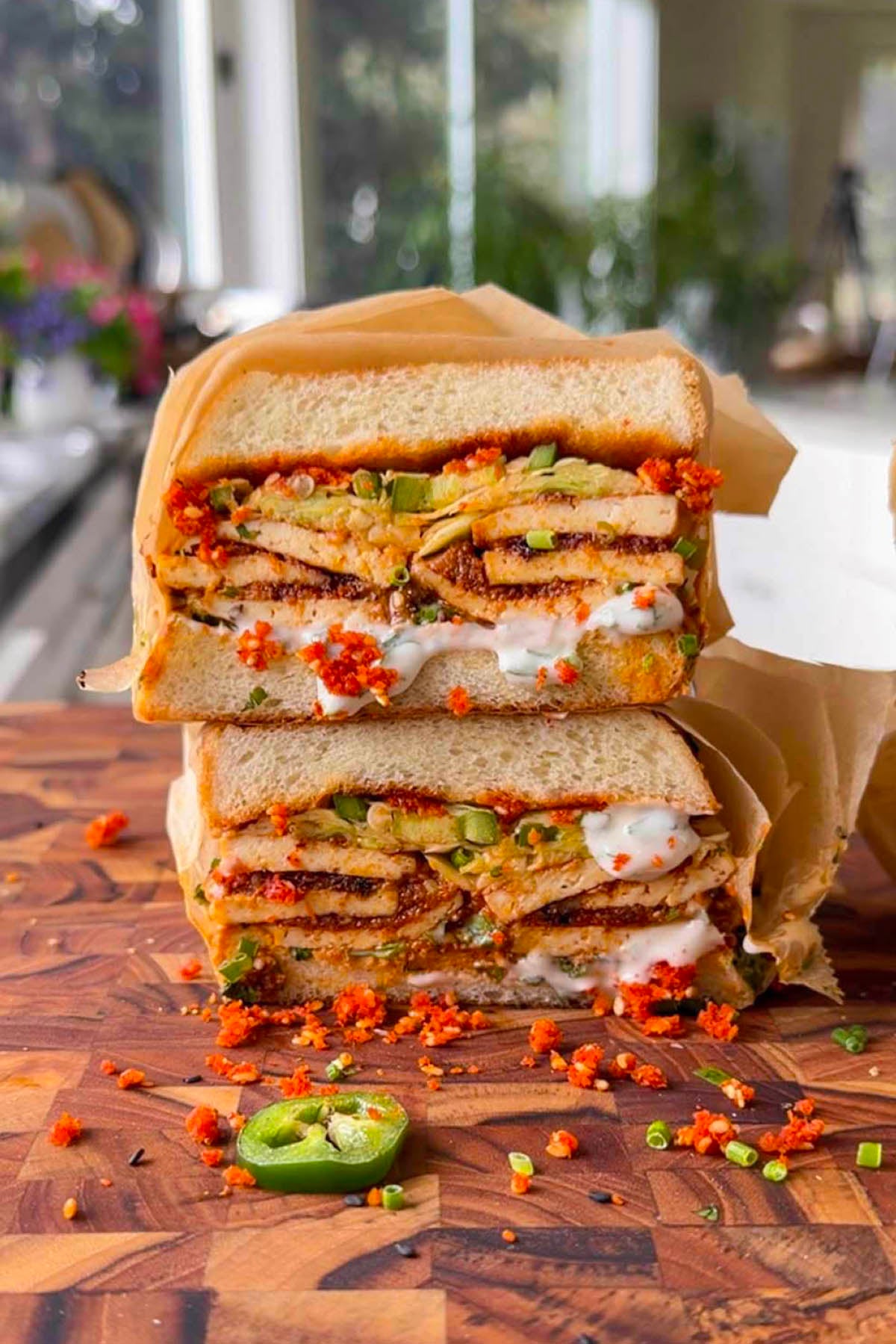 stack of coconut tofu sandwiches on a cutting board