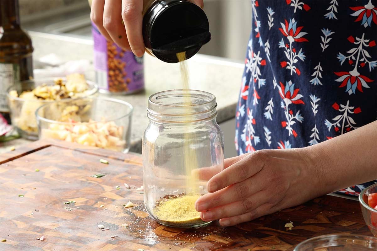 adding nutritional yeast to the jar