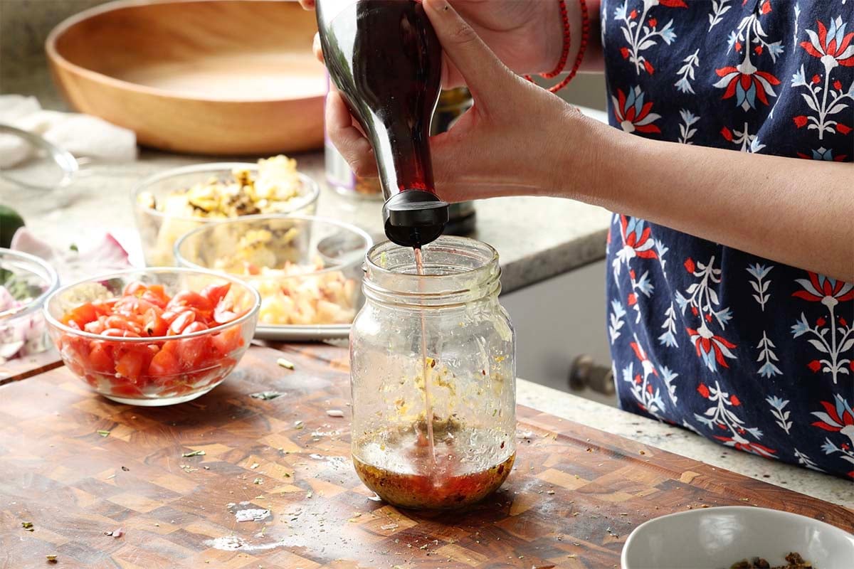 adding red wine vinegar to the dressing