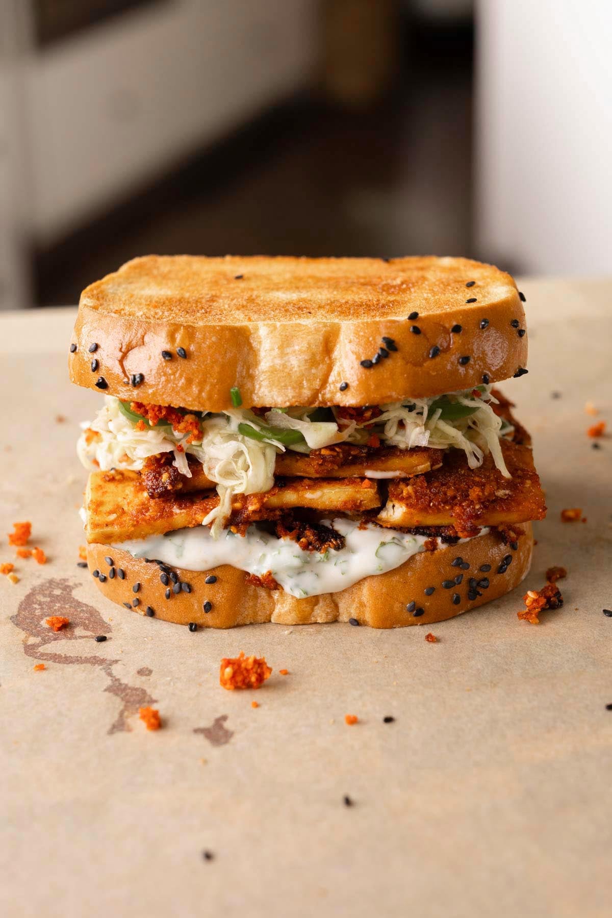 coconut tofu sandwich on a cutting board after assembling