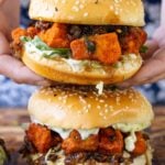 close-up of hands holding the crispy curry tofu sandwich