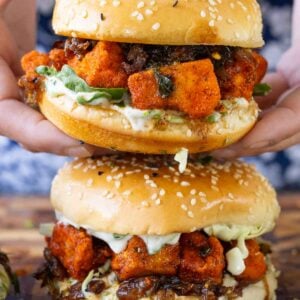close-up of hands holding the crispy curry tofu sandwich