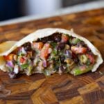 dense bean salad in a pita