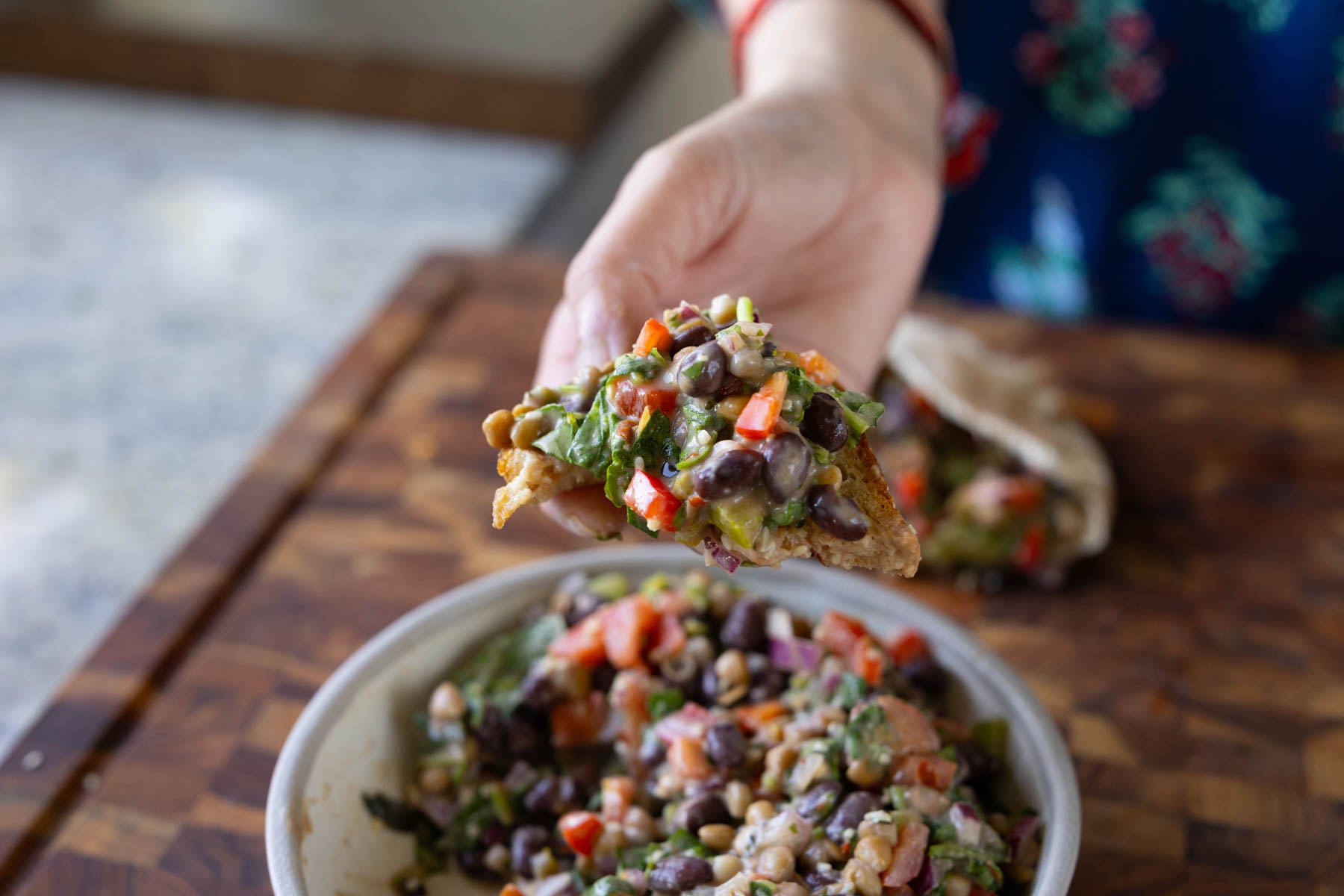 toasted bread scooping up some dense bean salad