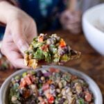 toasted bread scooping up some dense bean salad