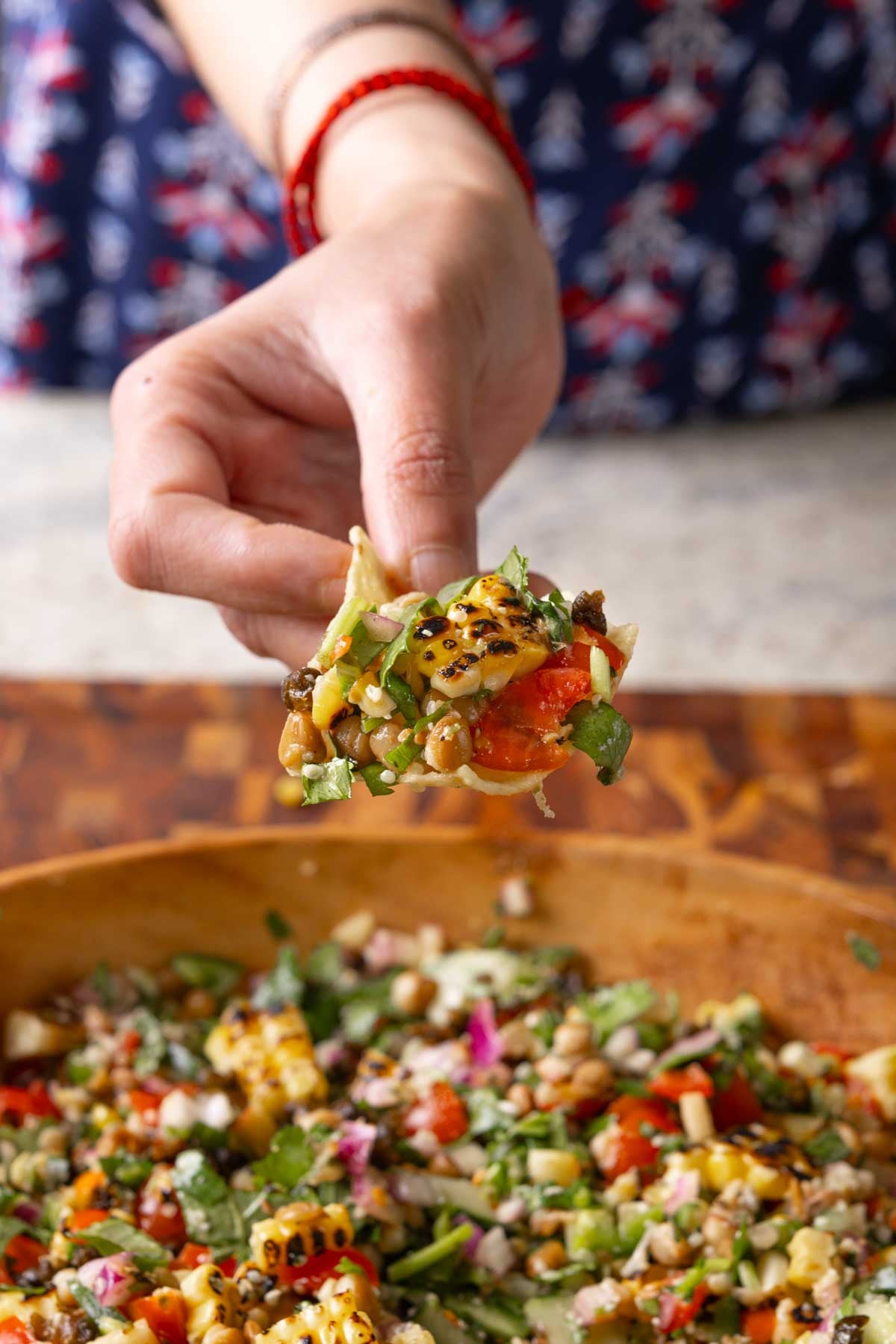scooping up lentil dip on a tortilla chip