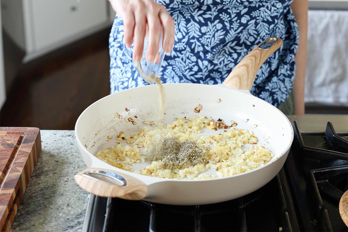 adding pepper to the pan