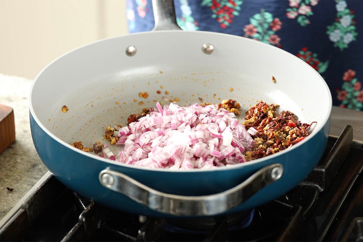 adding onions to the pan